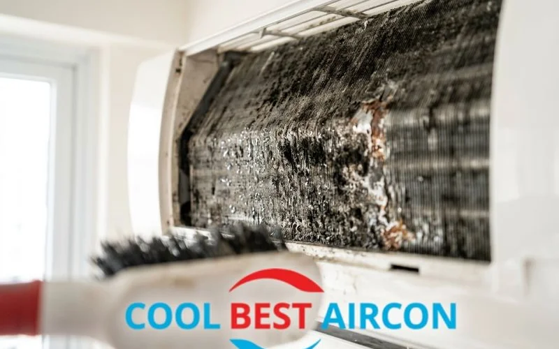 Close up of heavily soiled aircon evaporator coil covered in mould and grime needing chemical wash